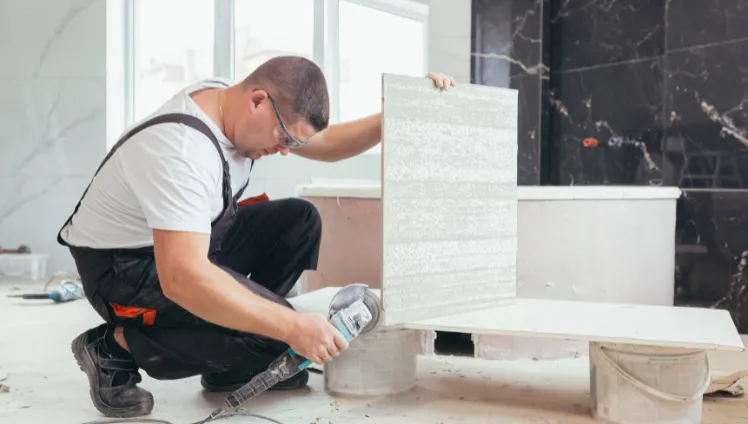 Home remodeling contractor in Los Angeles CA cutting tile during residential renovation project